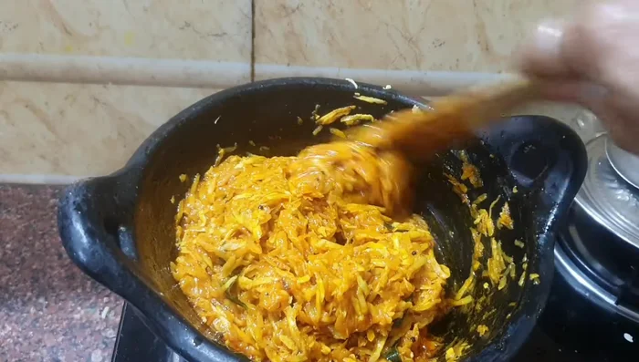 Simmer on low heat until the mango is cooked and the oil separates.