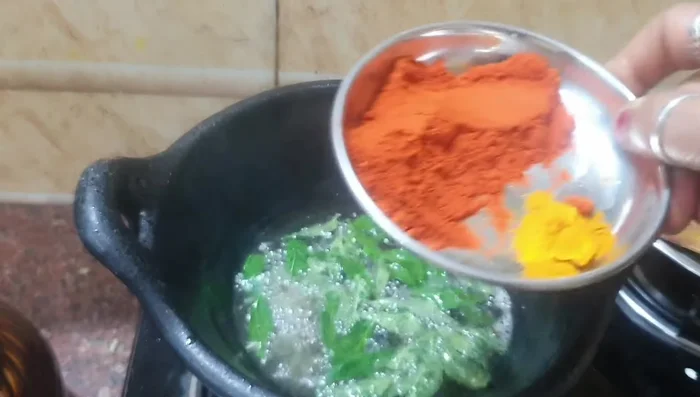 Add 1 teaspoon turmeric powder and 1.5 tablespoons coriander powder. Stir well.