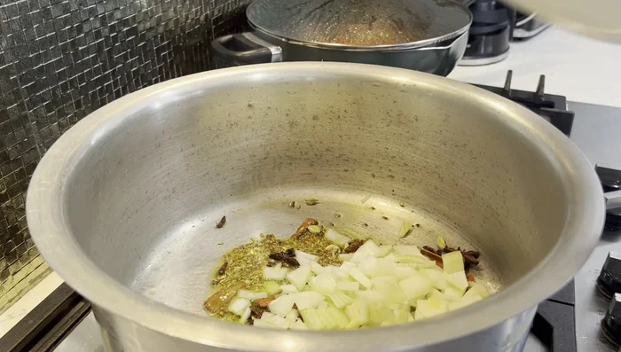 Add curry leaves and onions, cook until translucent and slightly browned.