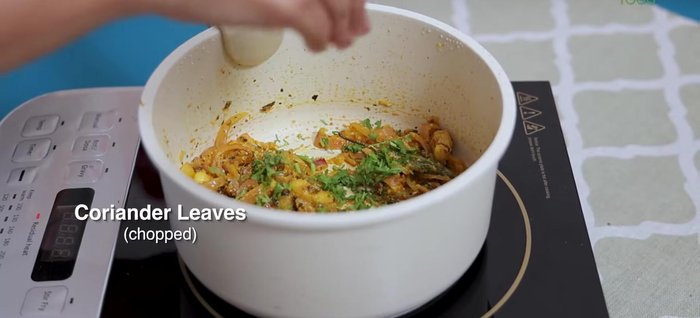 Add coriander leaves and 1/4 cup tomato puree.
