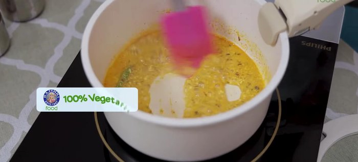 Switch on the flame and cook the yogurt. Switch off the flame, then add sliced onions, a little kasuri methi, and 8-9 cashews.