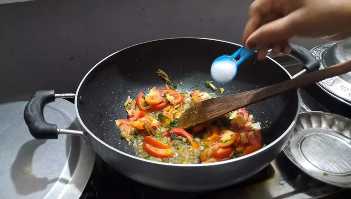 Fry tomatoes until softened.