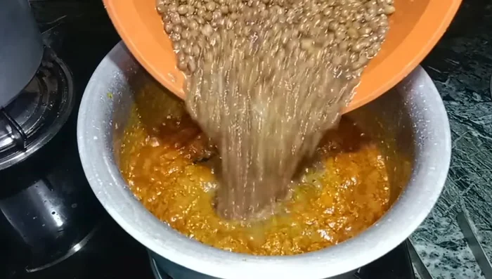 Add the boiled lentils to the tadka. Mix well.
