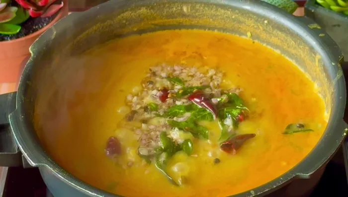 Add the tempering to the sambar, mix well, and let it simmer for 1-2 minutes.