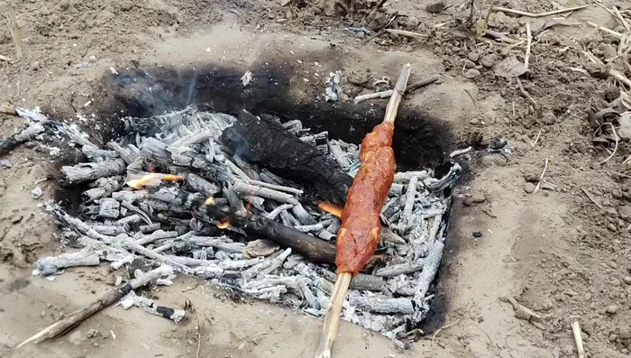 Grill the kebabs over the fire, rotating frequently, until fully cooked. This takes about 1.5 hours.
