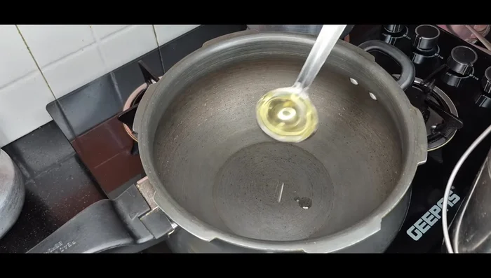 Heat cooking oil in a cooker.