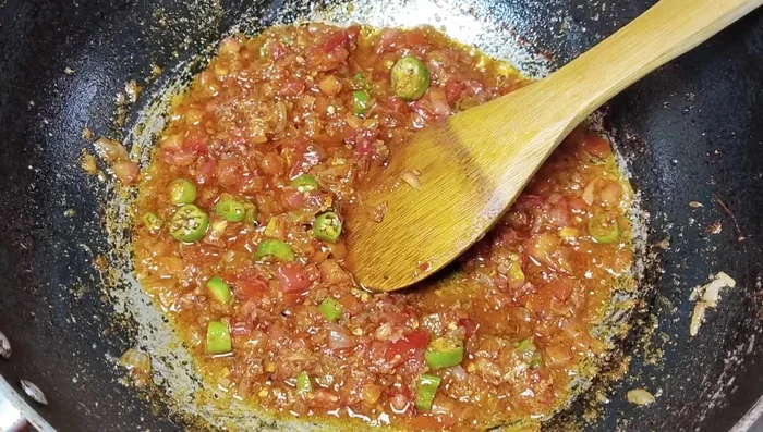 Add half a cup of water, and continue cooking until the tomatoes are soft.