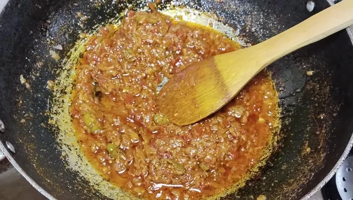 Add the fried bitter gourd to the tomato mixture.