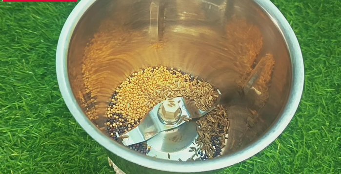 In a mortar and pestle (or grinder), combine black mustard seeds, yellow mustard seeds, cumin seeds, garlic, black salt, and white salt. Grind coarsely.