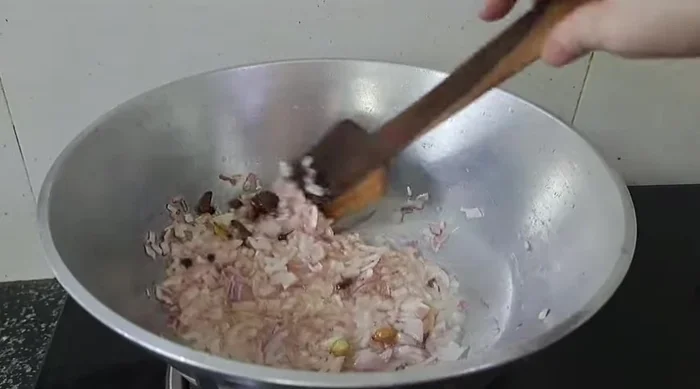 Add finely chopped onions and fry until brown. Add chopped tomatoes and cook until soft.
