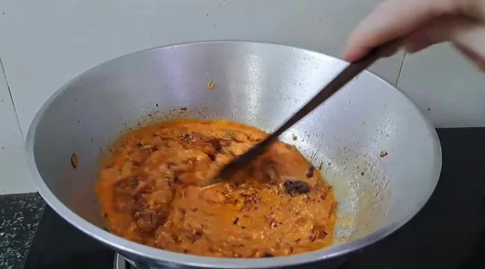Add the spiced curd and fry until oil separates.