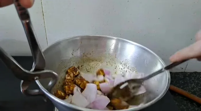 Mix the layered onions with the paneer and cook lightly.