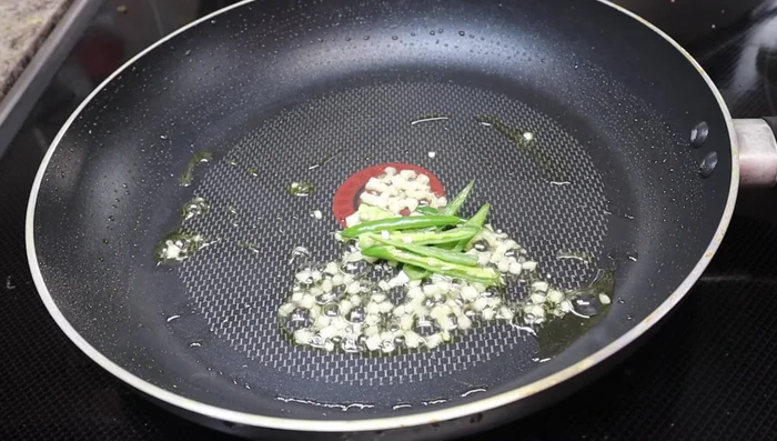 Add the green chilies, onion, and capsicum. Fry for 3-4 minutes, or until vegetables reach desired tenderness.