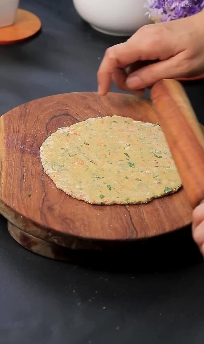 Roll out the dough into a circle using a rolling pin. Use a round cutter to shape it neatly (optional).