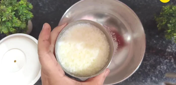 In a mixing bowl, add salt, sugar powder, curd, and water (equal to the amount of curd). Beat well.