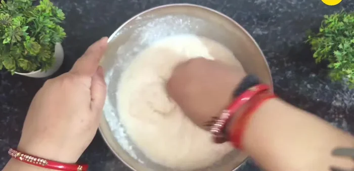 Add the semolina to the curd mixture and mix well with your hands for about 1 minute.