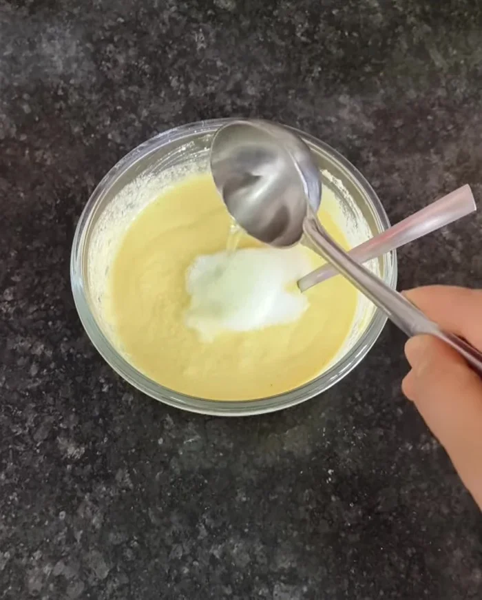 Add 1 teaspoon of Eno fruit salt (or baking soda) to the batter and mix quickly.