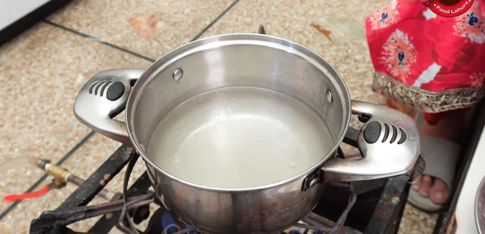 Boil water in a vessel, add salt, and then add the soaked lentils. Let it boil.