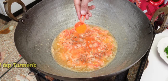 Add white cumin, turmeric, dried coriander, Kashmiri red chili, black pepper, ground cumin, crushed red chili, and garam masala. Sauté for a few minutes.