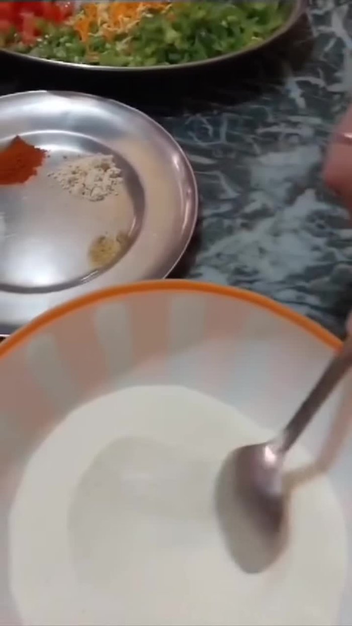 In a bowl, mix semolina and half a bowl of curd.