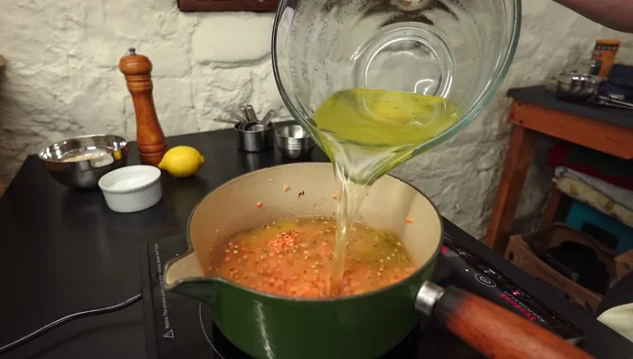 Add vegetable stock or water, ground turmeric, and black pepper.