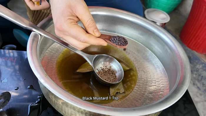 Add bay leaves, cumin seeds, and mustard seeds to the hot oil. Roast for 30 seconds.