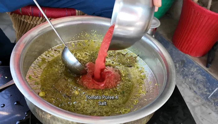 Add tomato puree, salt, and cook for 5 minutes on high flame, then lower the flame.