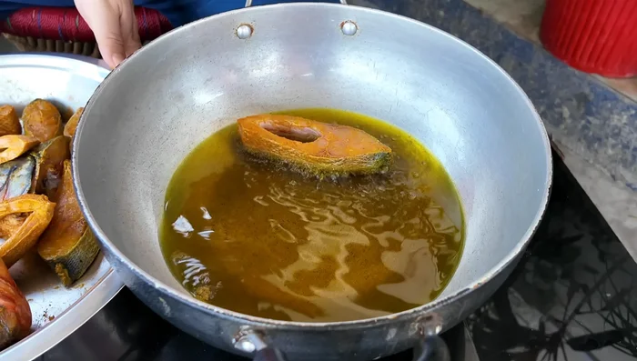 Heat oil in a pan. Fry the fish until golden brown on both sides (about 7-8 minutes per side).