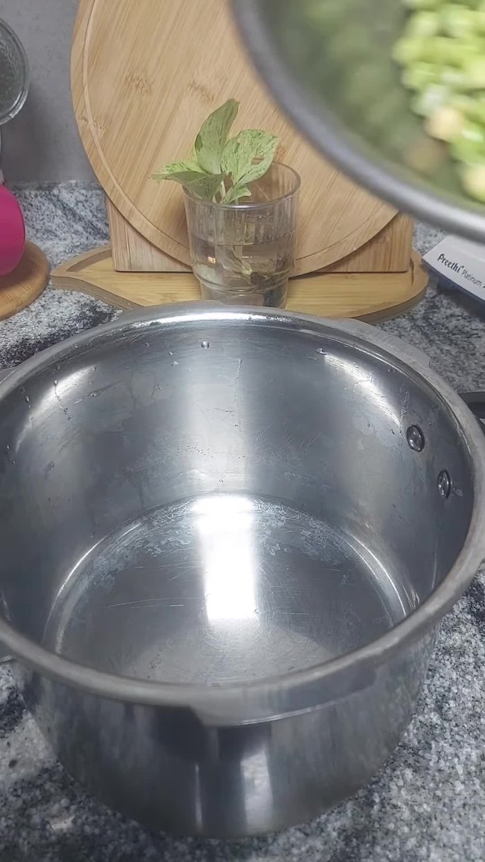 Add half an onion, half a tomato, some crushed garlic, crushed ginger, salt, 3/4 teaspoon turmeric powder, and enough water.