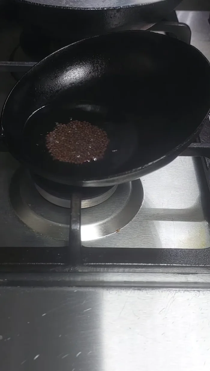 Add mustard seeds and finely chopped red chilies.