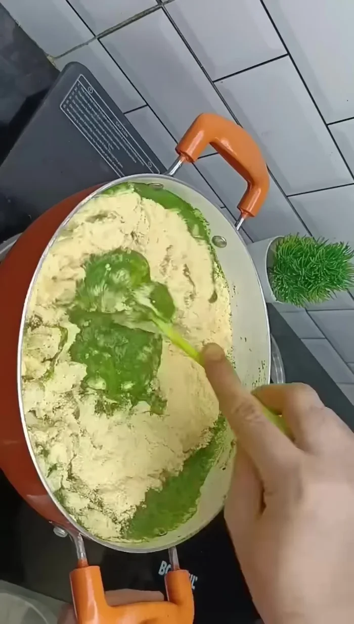 Gradually add corn flour to the spinach paste, adjusting with water until you get a slightly soft dough. (If it's too liquid, add more cornflour; if too thick, add more water).