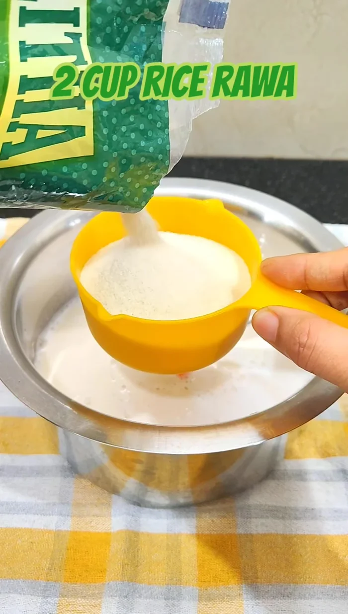 Add Idli Rava (2 cups for every 1 cup of urad dal). Mix well with the urad dal paste.