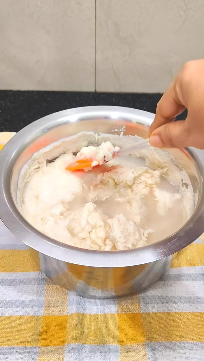 Gradually add water to the batter and beat vigorously for 5-7 minutes until light and fluffy.
