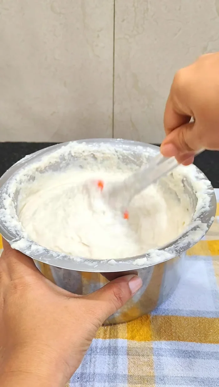 Gently stir the fermented batter to release air bubbles.