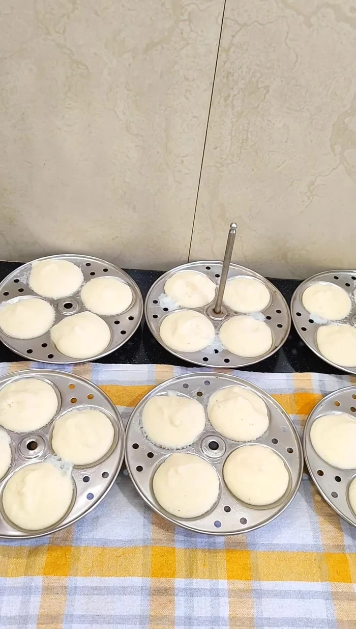 Carefully remove the idlis from the moulds and serve hot.