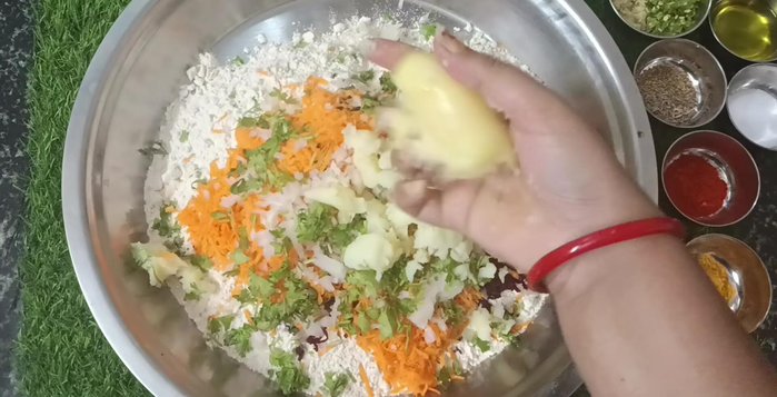 Add mashed boiled potatoes, chopped coriander, turmeric powder, red chili powder, salt, and green chili-ginger paste.