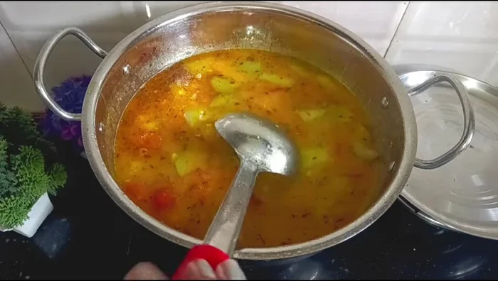 Add the boiled vegetables and their water to the dal mixture.