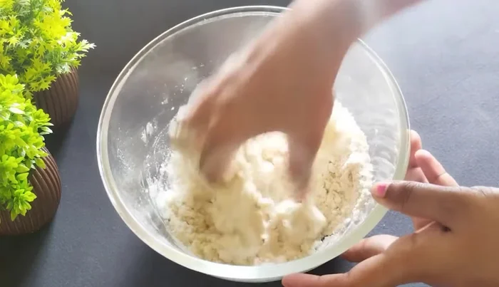 Gradually add water to form a stiff dough. The dough should be firm, like a confectioner's dough.