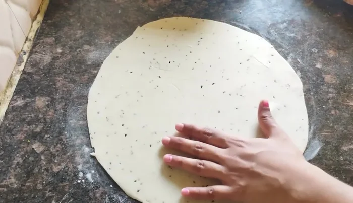 Sprinkle dry flour on the rolled-out dough to prevent sticking when cutting.