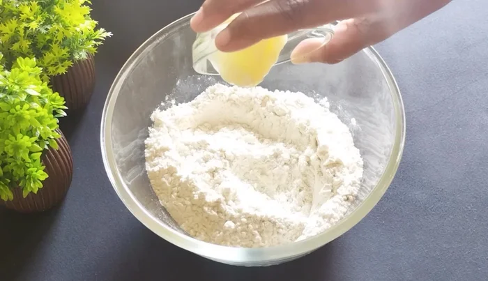 Add 2 tablespoons of ghee (or 4 tablespoons of refined oil/melted ghee) and rub into the flour until well combined.