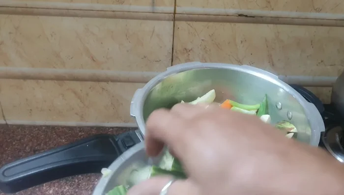Add curry leaves and drumstick pieces once the vegetables are heated through. (105.479)