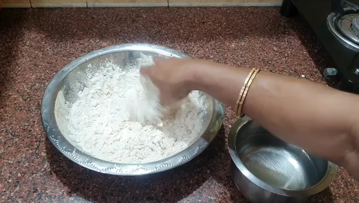 Sprinkle a little flour to prevent sticking and continue kneading until the dough is smooth and elastic. It shouldn't stick to the surface.