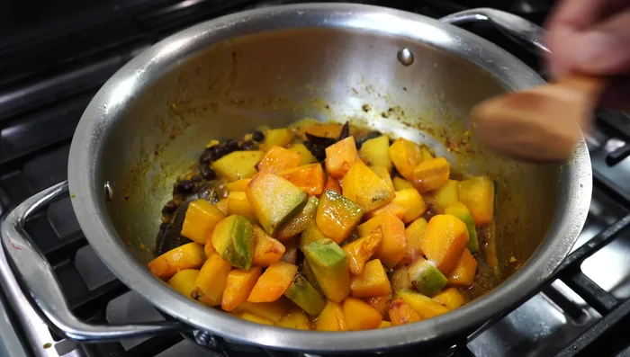 Add the fried pumpkin, 1/4 teaspoon more salt, 1 teaspoon of Bengali garam masala powder, and 1 teaspoon of sugar (optional). Add another 1/4 cup of hot water. Cover and simmer for about 6 minutes until the pumpkin is tender but not mushy.