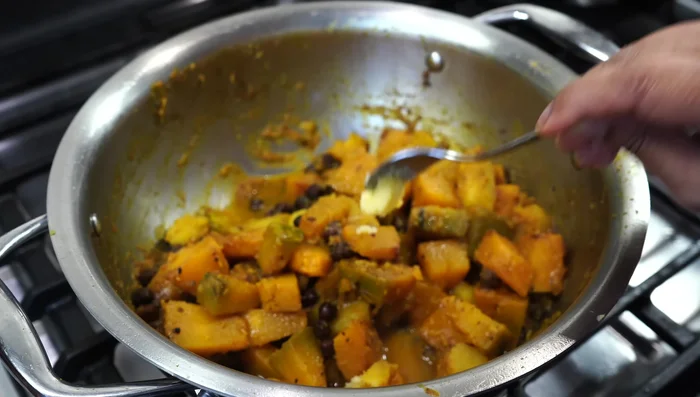 Stir in 1/2 teaspoon of ghee (clarified butter). Serve hot with roti, puri, or rice. Garnish with fresh coconut (optional).
