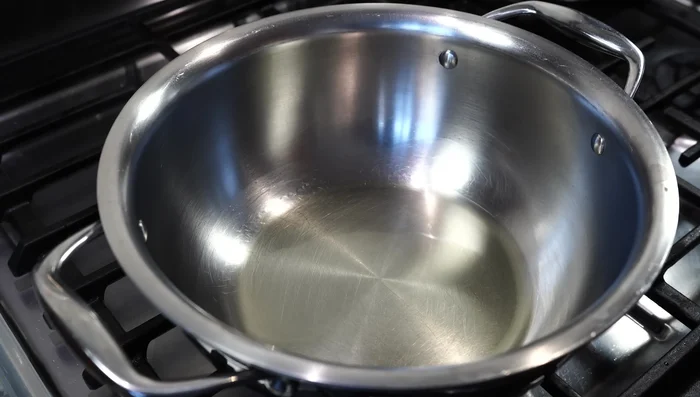 Heat 3 tbsp of oil in a pot over medium heat. Add chopped pumpkin and fry until lightly browned.