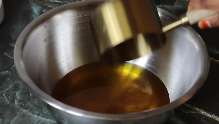 In a mixing bowl, add ¾ cup of melted ghee and 1 cup of sugar (brown or regular). Mix well until the sugar dissolves.