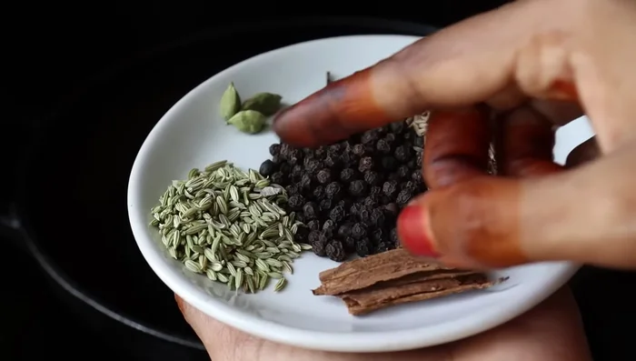 Prepare a powder by heating cumin, pepper, anise, bay leaves, cardamom pods, and cloves in a pan on low flame until fragrant. Add curry leaves and fenugreek leaves (fresh or dried), fry briefly, and let cool completely.