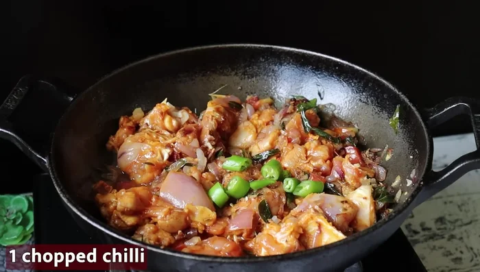 Add the green chili to the cooked chicken and mix. Add the ground spice powder and mix well.