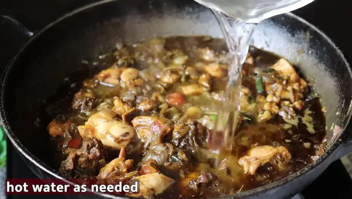 Add water as needed, bring to a boil, cover, and cook on medium flame until chicken is fully cooked and the sauce thickens.