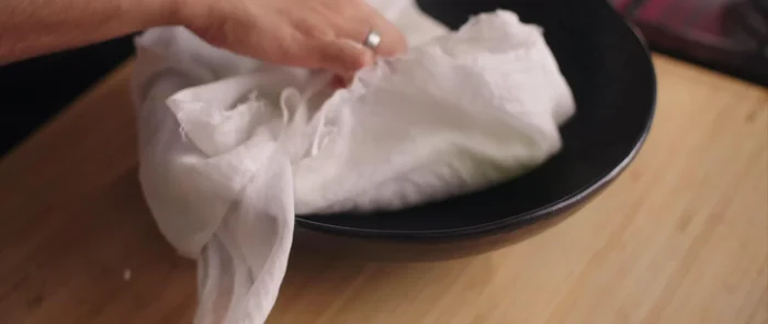 Mix the grated gourd with salt and let it sit for 1-2 minutes to extract excess water. Squeeze out the water using a muslin cloth.